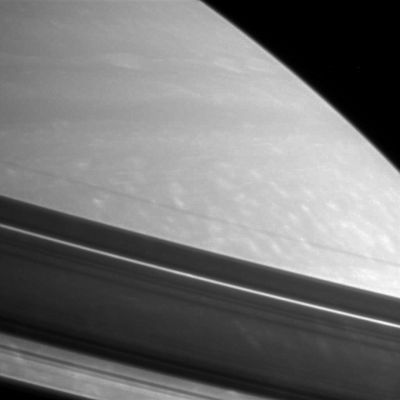 The texture of the Rings and Northern Regions of Saturn
Shadows drape Saturn's Northern Hemisphere, providing a different kind of look at prominent features in the Rings. From the lower left corner upward, the visible features are: the shadow of the outer B-Ring, followed by the wide, bright Cassini Division, then the A-Ring with the embedded thin, bright Encke Gap and finally the dark, narrow, F-Ring.

The image was taken with the Cassini spacecraft narrow-angle camera on Feb. 18, 2006, using a filter sensitive to wavelengths of infrared light centered at 750 nnmts, and at a distance of approx. 2,8 MKM (such as about 1,7 MMs) from Saturn. The image scale is roughly 16 Km (about 10 miles) per pixel.
Parole chiave: Saturn - Atmosphere - upper layers and Rings