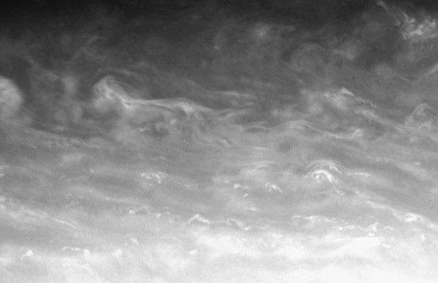 Saturnian (swirling) clouds
Caption NASA originale:"The bright whorls and small-scale specks of convective clouds drift through a Region just North of Saturn's bright Equatorial Band. Observers have seen major storms develop in this Region in the past 15-20 years. 

The image was taken in visible red light with the Cassini spacecraft narrow-angle camera on March 13, 2006, at a distance of approximately 2,6 MKM (about 1,6 MMs) from Saturn. The image scale is approx. 15 Km (about 9 miles) per pixel".
Parole chiave: Saturn - Atmosphere - upper layers