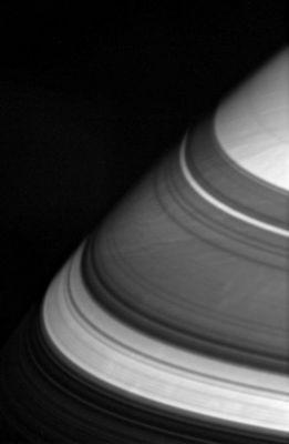 Through the Rings...
Caption NASA originale:"The dark shadows that drape Saturn's Northern Latitudes are split by 3 familiar bright gaps. From bottom to top, Sunlight passes through the broad Cassini Division (4.800 Km - or about 2.980 miles - wide), the Encke Gap (325 Km - or about 200 miles - wide) and (barely visible) the Keeler Gap (42 Km - or about 26 miles - wide). 

It is unlikely that the shadows cast by Saturn's Rings have much of an effect on the large-scale movements of the atmosphere. The dynamic clouds of this Gas Giant are driven by processes going on much deeper inside the Planet, where Sunlight does not penetrate. 

The image was taken using a spectral filter sensitive to wavelengths of infrared light centered at 752 nanometers. The image was acquired with the Cassini spacecraft wide-angle camera on April 28, 2006 at a distance of approximately 377.000 Km (about 234.000 miles) from Saturn. Image scale is roughly 19 Km (such as about 12 miles) per pixel".
Parole chiave: Saturn - Atmosphere - upper layers