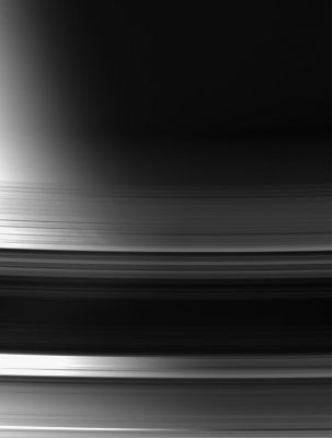 The Rings over Saturn's Terminator
Caption NASA originale:"With Saturn's Terminator as a backdrop, this view of the unlit face of the Rings makes it easy to distinguish between areas that are actual gaps, where light passes through essentially unimpeded, and areas where the Rings block or scatter light. The gaps are regions in which the brightness varies strongly from left to right as the background goes from bright to dark. 
Parts of the image are saturated at left. 

The image was taken in visible light with the Cassini spacecraft wide-angle camera on July 24, 2006 at a distance of approx. 577.000 Km (such as about 359.000 miles) from Saturn and at a Sun-Saturn-spacecraft, or phase, angle of 101°. Image scale is roughly 31 Km (about 19 miles) per pixel".
Parole chiave: Saturn's Rings