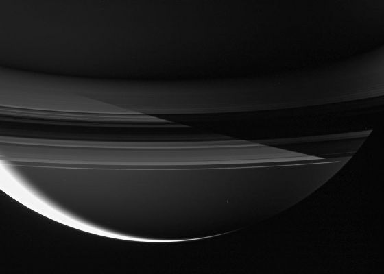 Night-flight around Saturn...
Caption NASA originale:"Saturn's shadow cuts sharply across the Rings in this remarkable night side view. 

The Planet's Northern Latitudes are in darkness in the upper portion of this scene, while the Southern reaches are bathed in Ringshine. On the left, Sunlight filters through the Rings, and on the right the Rings are blocking the reflected Ringshine in the shadow of Saturn. The overexposed, sunlit crescent at lower left marks the transition from Saturnian day to night. 

Mimas hovers below center - a tiny bauble, ornamenting the Ringed Giant. 

The image was taken in visible green light with the Cassini spacecraft wide-angle camera on August 19, 2006 at a distance of approx. 1,5 MKM (about 1 MMs) from Mimas and 1,7 MKM (about 1,1 MMs) from Saturn. 
Image scale is roughly 92 Km (about 57 miles) per pixel on Mimas and approx. 103 Km (about 64 miles) on Saturn".
Parole chiave: Postcard from Saturn