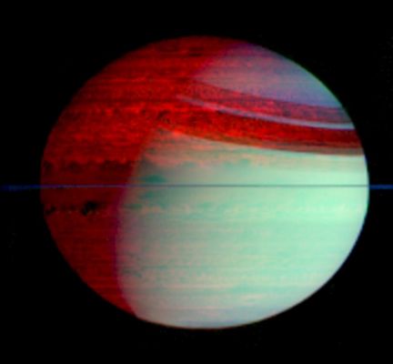 The clouds of Saturn
This false-color mosaic of Saturn shows deep-level clouds silhouetted against Saturn's glowing interior. The image was made with data from Cassini's VIMS, which can image the Planet at 352 different wavelengths. This mosaic shows the entire Planet, including features like Saturn's Ring shadows and the Terminator, the boundary between day and night. 
The data were obtained in February 2006 at a distance of 1,6 MKM (about 1 MMs) from directly over the plane of Saturn's Rings, which appear here as a thin, blue line over the equator. The image was constructed from images taken at wavelengths of 1,07 microns (blue), 2,71 microns (green) and 5,02 microns (red). 
The blue-green color (lower right) is Sunlight scattered off clouds high in Saturn's atmosphere and the red color (upper left) is the glow of thermal radiation from Saturn's warm interior, easily seen on Saturn's night side (top left), within the shadow of the Rings and with somewhat less contrast on Saturn's day side (bottom right). The darker areas within Saturn show the strongest thermal radiation. The bright red color indicates areas where Saturn's atmosphere is relatively clear. The great variety of cloud shapes and sizes reveals a surprisingly active planet below the overlying sun-scattering haze. 

The brighter glow of the northern hemisphere versus the southern indicates that the clouds and hazes there are noticeably thinner than those in the south. Scientists speculate that this is a seasonal effect, and if so, it will change as the northern hemisphere enters springtime during the next few years.

Parole chiave: Saturn - Upper Atmosphere