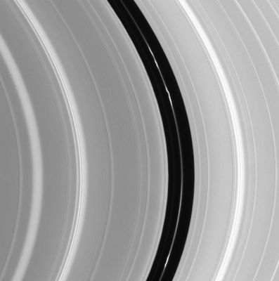 The "Encke Gap" of Saturn's Rings
Caption NASA originale:"An intriguing knotted ringlet within the Encke Gap is the main attraction in this Cassini image. The Encke Gap is a small division near the outer edge of Saturn's rings that is about 300 Km wide. The tiny moon Pan (20 Km across) orbits within the gap and maintains it. 
Many waves produced by orbiting moons are also visible. 
The image was taken in visible light with the Cassini spacecraft narrow angle camera on Oct. 29, 2004, at a distance of about 807,000 Km from Saturn. The image scale is 4,5 Km per pixel". 

Parole chiave: Saturn's Rings