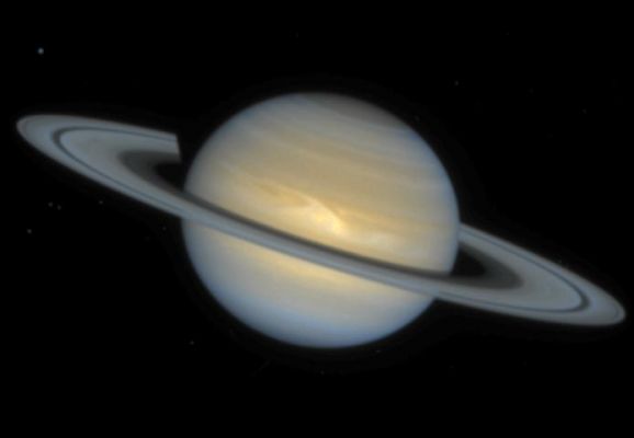 Saturn's Clouds from Hubble Space Telescope
Caption NASA originale:"This NASA Hubble Space Telescope image of the ringed planet Saturn shows a rare storm that appears as a white arrowhead-shaped feature near the planet's equator. The storm is generated by an upwelling of warmer air, similar to a terrestrial thunderhead. The east-west extent of this storm is equal to the diameter of the Earth (about 7,900 miles). Hubble provides new details about the effects of Saturn's prevailing winds on the storm. The new image shows that the storm's motion and size have changed little since its discovery in September, 1994".
Parole chiave: Saturn