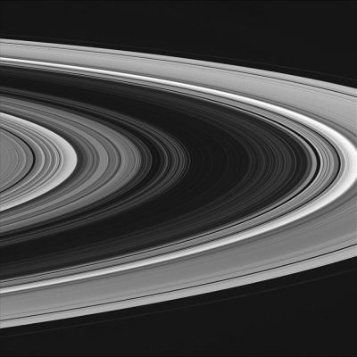 Saturn's Rings from about 631.000 Km
Caption NASA originale:"The usually bright B-Ring (at center) appears very dim in this view of the rings taken on the side of the rings that is not illuminated. The scene resembles a photographic negative, with bright and dark areas reversed (although in some places in the rings, the blackness of space is seen). From this viewing angle, the rings are lit from below: both dense and empty regions are dark, and regions of intermediate particle density are bright. 
The image was taken with the Cassini spacecraft wide angle camera on Oct. 27, 2004, at a distance of about 631.000 Km from Saturn through a filter sensitive to wavelengths of visible violet light. The image scale is 34 Km per pixel". 
Parole chiave: Saturn's Rings