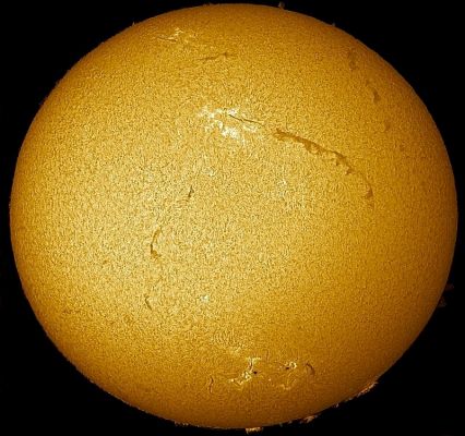 Sun filaments
Caption NASA originale, da NASA Picture of the Day del 6 Dicembre 2004:"Two unusually long filaments crossed part of the Sun last week. The filaments are actually relatively cool and dark prominences of solar plasma held up by the Sun's magnetic field but seen against the face of the Sun. Filaments typically last a few weeks before falling back. Pictured above, the two filaments are visible on the Sun's right side. It would take twenty Earths, set end-to-end, to match the length of one of the filaments. Also visible are bright hot regions called plages and a carpet of hundreds of granules that provide the Sun's texture. The above image was taken early last week through a small telescope in a very specific color of light emitted primarily by hydrogen".
Parole chiave: The Sun