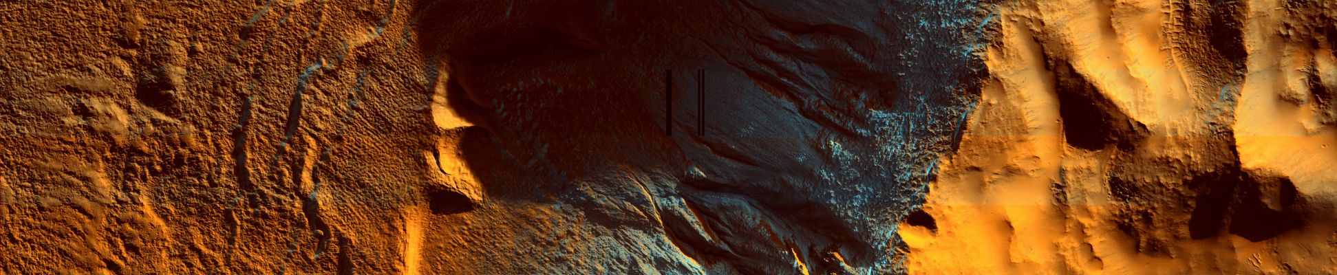 Terra Sirenum
This region receives very little sunlight in Southern Winter, and the bluish areas consist of frost. At the latitude of this image, frost is most likely composed of water because the temperature is not low enough for CO2 condensation. The reddish regions are locations where frost has been removed, most likely by sublimation. The dark, unfrosted regions (for example, in the channel of the gully on the far right) represent the most recent activity in the gullies and are possibly a result of seasonal melting. 
Parole chiave: Mars from orbit - Terra Sirenum