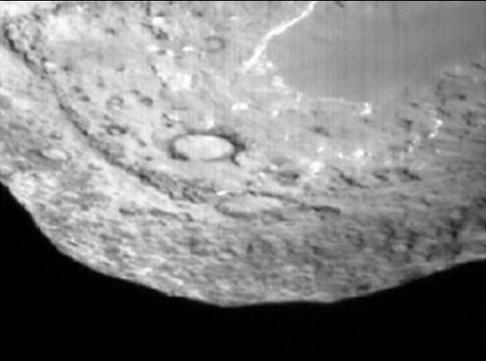 The South-Pole of Tempel-1 and the impact area
Da "NASA - Picture of the Day" del 6 Luglio 2005:"This diverse landscape is the surface of comet Temple-1's nucleus as seen by the Deep Impact probe's Impactor Targeting Sensor. Within minutes of recording the rugged view, the landscape had changed dramatically though, as the impactor smashed into the surface near the two large, half kilometer-sized craters at picture center. Indications are that the probe penetrated well below the surface before vaporizing, sending a relatively narrow plume of debris blasting back into space. Researchers are still speculating on the final size of the crater produced by the July 4th comet crash, but material continues to spew from the impact site and has caused the faint comet to brighten significantly. Determining the crater dimensions and analyzing the debris ejected from the comet's interior will provide premier insights into the formation of comet Tempel 1, a primordial chunk of our own Solar System". 
Parole chiave: Comet Tempel-1