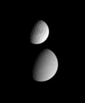 Tethys and Dione
Original caption:"This image shows Tethys partially occulting Dione. For comparison purposes, we remind you that the diameter of Tethys is 1.071 Km (about 665 miles), while Dione is 1.126 Km (such as about 700 miles) across; the difference in the surface brightness of the two moons is immediately apparent. 

This still image was acquired on Sept. 16, 2005, at a distance of 2,1 MKM (such as about 1,3 MMs) from Dione and 2,7 MKM (about 1,7 MMs) from Tethys. Resolution in the original images was 13 Km (approx. 8 miles) per pixel on Dione and 16 Km (approx. 10 miles) per pixel on Tethys. 
The image was magnified by a factor of two to aid visibility of surface features".
Parole chiave: Saturn's Moons - Dione and Tethys
