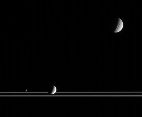 Wonderful Trio, in Saturn's Space
Caption originale:"The three very different moons seen here provide targets of great interest for planetary scientists studying the Saturn System. Captured here by Cassini, along with the Rings, are Tethys at upper right, Enceladus below center and Janus at lower left. 
Researchers study the orbital dance of Janus (181 Km, or about 113 miles across) with Epimetheus, tectonics and cratering on Tethys (1.071 Km, or approx. 665 miles across) and geyser activity on Enceladus (505 Km, or about 314 miles across). And these are only a few of the wonders that await exploration in the realm of the Ringed Planet. 

The image was taken in visible light with the Cassini spacecraft narrow-angle camera on March 16, 2006, at a distance of approx. 2,4 MKM (such as about 1,5 MMs) from Tethys; 1,9 MKM (about 1,2 MMs) from Enceladus and 2,2 MKM (roughly 1,4 MMs) from Janus. The image scale is about 14 Km (appx. 9 miles) per pixel on Tethys, 11 Km (about 7 miles) p. px. on Enceladus and 13 Km (about 8 miles) p. px on Janus".
Parole chiave: Saturn's Moons - Tethys, Enceladus and Janus