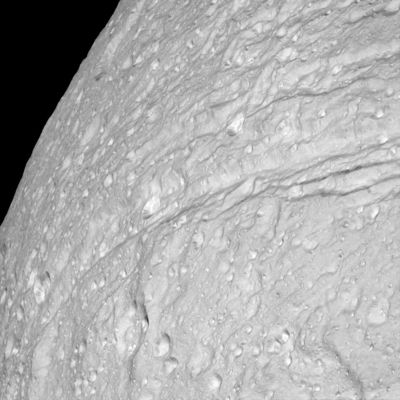 Icy cliffs, canyons and crevasses on Tethys (HR)
Original caption:"The surface of Saturn's moon Tethys is riddled with icy cliffs and craters. The most detailed images ever taken of Tethys were captured late last month as Cassini spacecraft swooped past the frozen ice moon. The above image was taken from from about 32.000 Km and shows a jagged landscape of long cliffs covered with craters. At the bottom of many craters appears some sort of unknown light-colored substance, in contrast to the unknown dark substance that appears at the bottom of Saturn's moon Hyperion. Tethys is one of the larger moons of Saturn, spanning about 1000 Km across and its density indicates a composition almost entirely of water ice. Tethys is thought to have been predominantly liquid sometime in its distant past, creating some of its long ice-cliffs as it cracked during freezing".
Parole chiave: Saturn's Moons - Tethys
