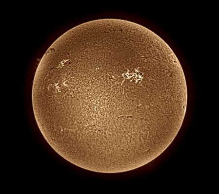 The Sun in "Hydrogen-alpha" light
Caption NASA originale:"The above picture was taken in a specific color of light emitted by Hydrogen gas called Hydrogen-alpha. Granules cover the solar photosphere surface like shag carpet, interrupted by bright regions containing dark sunspots. Our Sun glows because it is hot, but it is NOT on fire. Fire is the rapid acquisition of oxygen, and there is VERY LITTLE O2 on the Sun! The energy source of the Sun is the nuclear fusion of Hydrogen into Helium (4H--->1He) deep within its core". 
Parole chiave: The Sun