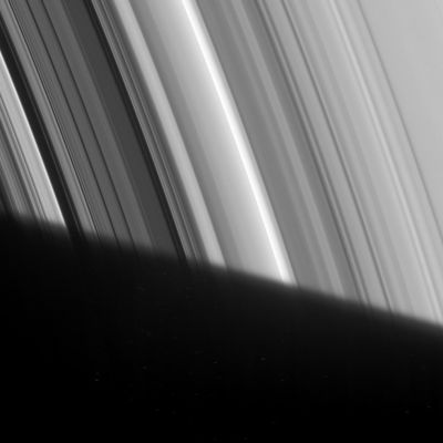 The "Cassini Division"
Caption NASA:"The Cassini Division appears to emerge out of Saturn's shadow in this Cassini spacecraft image. This Division between the A and B Rings, visible through modest telescopes from Earth, actually contains five dim bands of ring material, here seen near the left side of the image between two small dark gaps. 
This detailed view also displays a great deal of structure in the B-Ring, left of the Division. The Cassini Division is 4800 Km (2980 miles) wide. This view looks toward the unlit side of the Rings from about 59° above the Ring-Plane. 

The image was taken in visible light with the Cassini spacecraft narrow-angle camera on Feb. 9, 2007 at a distance of approx. 1,7 MKM (about 1,1 MMs) from Saturn. 
Image scale is roughly 10 Km (about 6 miles) per pixel".
Parole chiave: Saturn's Rings - The Cassini Division