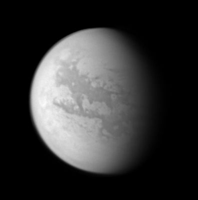 Titan in three different wavelenghts: the monochrome Titan (1)
Caption NASA originale:"This image composite was created with images taken during the Cassini spacecraft's closest flyby of Titan on April 16, 2005. Cassini's cameras have numerous filters that reveal features above and beneath the shroud of Titan's atmosphere. 
This monochrome view shows what Titan looks like at 938 nnmts, a near-infrared wavelength that allows Cassini to see through the hazy atmosphere and down to the surface. The view was created by combining 3 separate images taken with this filter, in order to improve the visibility of surface features. The variations in brightness on the surface are real differences in the reflectivity of the materials on Titan. North on Titan is up and tilted 30° to the right".
Parole chiave: Saturn's Moons - Titan