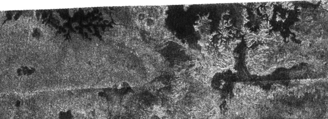 Titanian Northern Lakes (4)
Caption NASA originale:"In this image taken by the Cassini radar system, a previously unseen style of lakes is revealed. The lakes here assume complex shapes and are among the darkest seen so far on Titan. 
The lake at the left is reminiscent both in form and scale of the flooded drainage system, Lake Powell in Utah and Arizona. However, the Titan lake has been filled with liquid methane and ethane rather than water. In the lake at right, older terrain may have been deeply cut by river valleys before it was flooded by the embaying lake. 

This radar image was acquired Oct. 9, 2006, and is centered near 80° North Latitude and 357° West Longitude. It measures about 310 by 100 Km (such as about 190 by 62 miles). Smallest details in this image are about 500 mt (approx. 1.640 feet) across".
Parole chiave: Saturn's Moons - Titan