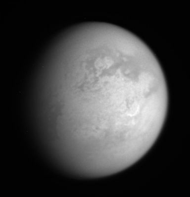 Smiling Titan...
This infrared view shows features on the Leading Hemisphere of Titan, including the bright, crescent-shaped Hotei Arcus (right of center), which is also informally called "the Smile" by researchers. 
The view is centered on the bright Region called Xanadu. Above center is the large crater Minerva, which is surrounded by darker material.

This image was taken with the Cassini spacecraft narrow-angle camera on Jan. 13, 2006 using a spectral filter sensitive to wavelengths of infrared light centered at 938 nnmts. The image was acquired at a distance of approx. 1,3 MKM (800.000 miles) from Titan and at a phase angle of 41°. Image scale is about 7 Km (approx. 5 miles) per pixel.
Parole chiave: Saturn's Moons - Titan