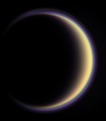 Crescent Titan
With its thick, distended atmosphere, Titan's orange globe shines softly, encircled by a thin halo of purple light-scattering haze. Images taken using blue, green and red spectral filters were used to create this enhanced-color view; the color images were combined with an ultraviolet view that makes the high-altitude, detached layer of haze visible. 
The ultraviolet part of the composite image was given a purplish hue to match the bluish-purple color of the upper atmospheric haze seen in visible light. 
Small particles that populate high hazes in Titan's atmosphere scatter short wavelengths more efficiently than longer visible or infrared wavelengths, so the best possible observations of the detached layer are made in ultraviolet light.

The images in this view were taken by the Cassini narrow-angle camera on May 5, 2005, at a distance of approx. 1,4 MKM (about 900.000 miles) from Titan and at a phase angle of 137°. 
Image scale is 8 Km (5 miles) per pixel.
Parole chiave: Saturn's Moons - Titan