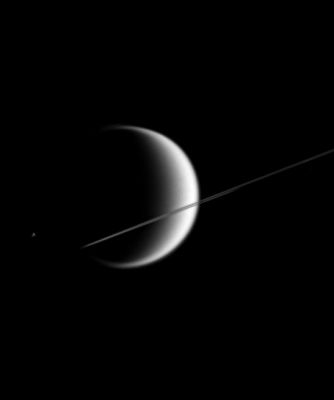 Titan & Epimetheus
Caption originale:"This poetic scene shows the giant, smog-enshrouded moon Titan behind Saturn's nearly edge-on Rings. 
Much smaller Epimetheus (116 Km - or 72 miles - across) is just visible to the left of Titan (5.150 Km - or 3.200 - miles across). 

The image was taken in visible light with the Cassini spacecraft narrow-angle camera on March 9, 2006, at a distance of approx. 4,1 MKM (such as about 2,5 MMs) from Titan. The image scale is 25 Km (about 16 miles) per pixel on Titan. The brightness of Epimetheus was enhanced for visibility purposes".
Parole chiave: Saturn's Moons - Titan and Epimetheus