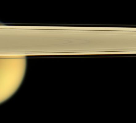 Mellow Yellow...
Caption NASA originale:"Saturn's largest moon, Titan, peaks out from under the Planet's Rings of ice. 
This view looks toward Titan from slightly beneath the Ring-Plane. The dark Encke Gap (325 Km, or 200 miles wide) is visible here, as is the narrow F-Ring. 

Images taken using red, green and blue spectral filters were combined to create this natural color view. 
The images were taken with the Cassini spacecraft narrow-angle camera on April 28, 2006 at a distance of approximately 1,8 MKM (such as 1,1 MMs) from Titan. Image scale is approx. 11 Km (about 7 miles) per pixel on Titan".
Parole chiave: Saturn's Moons - Titan