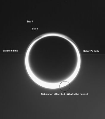 Haze and saturation
Caption NASA originale:"Sunlight streams through the high-altitude haze layer that extends completely around the giant moon, Titan, in this view of the moon taken by the Cassini spacecraft. Some fine structure can be spotted in the ever-shifting hazes in Titan's Northern Polar reaches to the top. 
The distant sky beyond Titan is not empty, but instead is filled in the lower half by the barely visible, immense bulk of Saturn, 1,3 MKM (such as approx. 800.000 miles) beyond. The view is toward the night side of both worlds. 

Titan's image is saturated, or over exposed, near the five o'clock position, obscuring the details in the atmosphere. 

The image was taken in visible light with the Cassini spacecraft narrow-angle camera on June 2, 2006 at a distance of approx. 2,3 MKM (about 1,4 MMs) from Titan and at a Sun-Titan-spacecraft angle of 163°. Image scale is roughly 14 Km (about 9 miles) per pixel on Titan".
Parole chiave: Saturn's Moons - Titan