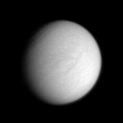 Fensal-Aztlan Region
Original caption:"The H-shaped region Fensal-Aztlan is faintly visible on Saturn's murky moon Titan in this enhanced clear-filter view from Cassini. 
While most of the light passing through the clear filters is visible light, a small portion of the light is in the treasured infrared windows that allow views down to the moon's frigid surface (nota: la NASA persiste nel definire Titano come un mondo "gelido". Forse è vero - a logica diremmo di si - ma i dati che possediamo non autorizzano ancora tale conclusione la quale, ovviamente, è ad oggi solo speculativa). 
At the upper left, dark wavelike features in the atmosphere encircle the moon's North Pole. 
The view shows principally the Saturn-facing Hemisphere on Titan; North is up and rotated 35° to the left. 

The image was taken with the Cassini spacecraft narrow-angle camera on Oct. 7, 2005, at a distance of approximately 2,4 MKM (about 1,5 MMs) from Titan and at a phase angle of 33°. The image scale is 14 Km (about 9 miles) per pixel".
Parole chiave: Saturn's Moons - Titan