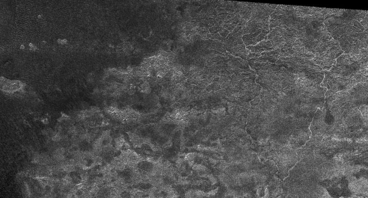 The rivers of Titan...
This image from the Synthetic Aperture Radar instrument on the Cassini spacecraft shows the radar-bright western margin of Xanadu, one of the most prominent features on Titan. 
In radar images, bright regions indicate a rough or scattering material, while a dark region might be smoother or more absorbing. This image was taken during a flyby of Titan on April 30, 2006. 

Narrow, sinuous, radar-bright channels, meandering like a maze, are seen on the right-hand-side of the image. These may be river networks that might have flowed onto the dark areas on the left of the image. Vast, dark areas covered by dunes are seen on the equatorial regions of Titan (see PIA03567) and have been referred to as Titan's "sand seas". Near the middle of the image is a radar-bright area that has a boundary with the dark sand seas. Because the radar illumination is coming from the top, this indicates that the bright region, Xanadu, is topographically higher than the sand seas.
Parole chiave: Saturn's Moons - Titan