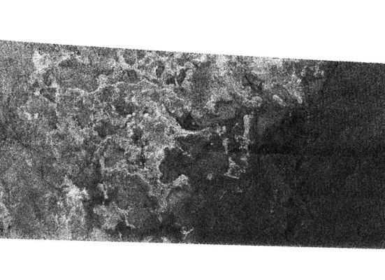 Shoreline on Titan?
Caption originale:"This SAR (Synthetic Aperture Radar) image of the surface of Saturn's moon Titan, was obtained by the Cassini spacecraft on Sept. 7, 2005. The bright, rough Region on the left side of the image seems to be topographically "high terrain" that is cut by "channels" and "bays". 
The boundary of the bright (rough) Region and the dark (smooth) Region appears to be a "shoreline". The patterns in the dark area indicate that it may once have been flooded, with the liquid having at least partially receded. 
The image is 175 Km high and 330 Km wide (about 109 by 205 miles), and is located at 66 degrees south latitude, 356° West Longitude in the Southern Hemisphere of Titan".
Parole chiave: Saturn's Moons - Titan