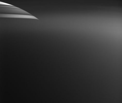 Saturn through the haze of Titan
Caption NASA originale:"Less than 20 minutes after Cassini's close approach to Titan on March 31, 2005, its cameras captured this view of Saturn through Titan's upper atmosphere. The northern part of Saturn's disk can be seen at the upper left; dark horizontal lines are shadows cast upon Saturn by its rings. Below this level, Titan's atmosphere is thick enough to obscure Saturn. 
The diffuse bright regions of the image (below Saturn and at the right) are light being scattered by haze in the upper reaches of Titan's atmosphere. 
This image is scientifically useful because it shows properties both of how Titan's haze transmits light (from the attenuation of light from Saturn) and of how the haze reflects light (from its brightness next to Saturn).
The image was taken in visible light with the Cassini spacecraft wide-angle camera at a distance of 7.980 Km (appx. 4.960 miles) from Titan, when Saturn was about 1,3 MKM (appx. 808.000 miles) away. Image scale is about 320 meters (1,050 feet) per pixel on Titan".
Parole chiave: Saturn and Titan
