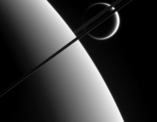 Father and Son
Caption originale:"Cassini's Eyes - such as its powerful imaging cameras -- bear witness to the majestic and spectacular sights of the Saturn System, as this views attests. Here, the probe gazes upon Titan in the distance beyond Saturn and its dark and graceful Rings. 
This view was taken from above the Ring-Plane and looks toward the unlit side of the Rings. 

The image was taken using a spectral filter sensitive to wavelengths of infrared light centered at 938 nnmts. 
The image was obtained using the Cassini spacecraft narrow-angle camera on May 10, 2006 at a distance of approx. 2,9 MKM (such as about 1,8 MMs) from Saturn and 4,1 MKM (about 2,6 MMs) from Titan. 
The image was taken at a phase angle of 149°. 
Image scale is about 17 Km (roughly 11 miles) per pixel on Saturn".
Parole chiave: Saturn and Titan