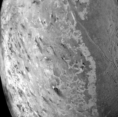 The South Polar Region of Triton: "dark plumes" and "seasonal winds"
Caption NASA originale:"This image of the South Polar terrain of Triton, taken on Aug. 25, 1989 reveals about 50 dark plumes or 'wind streaks' on the icy surface. The plumes originate at very dark spots generally a few miles in diameter and some are more than 100 miles long. The spots which clearly mark the source of the dark material may be vents where gas has erupted from beneath the surface and carried dark particles into Triton's nitrogen atmosphere. Southwesterly winds then transported the erupted particles, which formed gradually thinning deposits to the northeast of most vents. It is possible that the eruptions have been driven by seasonal heating of very shallow subsurface deposits of volatiles and the winds transporting particles similarly may be seasonal winds. The polar terrain, upon which the dark streaks have been deposited, is a region of bright materials mottled with irregular, somewhat dark patches. The pattern of irregular patches suggests that they may correspond to lag deposits of moderately dark material that cap the bright ice over the polar terrain".
Parole chiave: Neptune's Moons - Triton