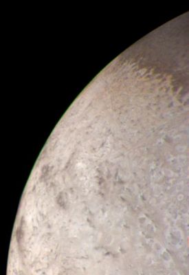 The limb of Triton (natural colors - elab. NASA)
Caption NASA originale:"This natural color image of the limb of Triton was taken early in the morning of Aug. 25, 1989, when the Voyager 2 spacecraft was at a distance of about 210.000 Km (128.000 miles) from the icy satellite. The largest surface features visible area about 3 miles across. The picture is a composite of images taken through the violet, green and clear filters. 
The image shows a geologic boundary between a rough, pitted surface to the right and a smoother surface to the left". 
Parole chiave: Neptune's Moons - Triton