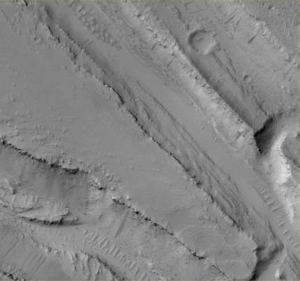 The Troughs of Olympica Fossae (2 - Original NASA/MGS/MSSS b/w Frame)
Caption originale:"This MGS-MOC image shows a complex pattern of intersecting and overlapping Troughs in the Olympica Fossae Region of Northern Tharsis. Some combination of Floods, Lava Flows and faulting/tectonic activity contributed to this scene, followed by mantling by dust. Dark Streaks on Slopes in the Troughs were formed by Dust Avalanches".

Location near: 24,8° North Lat. and 114,8° West Long.
Image width: ~3 Km (~1,9 mi)  
Illumination from: lower left  
Season: Northern Winter  

Parole chiave: Mars from orbit - Volcanic Features - Troughs
