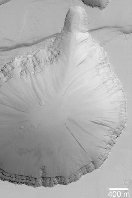 Collapse Pit in Tractus Fossae (Original NASA/MGS/MSSS b/w Frame)
Caption NASA originale:"Extensional faulting, wherein some fraction of the Martian Crust is pulled apart and Faults are formed where the Bedrock breaks, has also led to formation of Collapse Pits in the Tractus Fossae Region. This MGS-MOC image shows one such pit and the layered bedrock exposed in its walls. Dark Streaks on the Slopes of the Pit result from Avalanches of dry, fine-grained debris (probably Dust, as these streaks are only found in the dust-mantled regions of Mars). 
This Pit is located near 23,5° North Lat. and 103,8° West Long. Sunlight illuminates the scene from the lower left".
Parole chiave: Mars from orbit - Volcanic Features - Collapse Pit