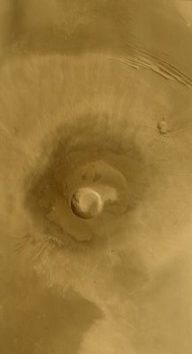 Pavonis Mons (Darkened Natural Colors; credits: NASA/MGS/MSSS)
Caption NASA originale:"This Mars Global Surveyor (MGS) Mars Orbiter Camera (MOC) wide angle color composite image, obtained in December 2003, shows the middle of the three Tharsis Montes, Pavonis Mons. This is a broad shield volcano -similar to the volcanoes of Hawaii - located on the Martian equator at 113°W. The volcano summit is near 14 Km (~8.7 mi) above the martian datum (0 elevation); the central caldera (crater near center of image) is about 45 Km (~28 mi.) across and about 4.5 Km (~2.8 mi.) deep. Sunlight illuminates the scene from the lower left".
Parole chiave: Mars from orbit