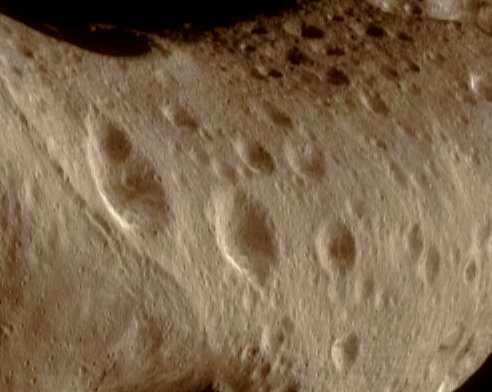 The North Polar Region of 433-Eros (natural colors; credits: Lunexit)
On March 11, 2000, this image of Eros' North Polar Region was acquired by the imager on the NEAR Shoemaker Spacecraft, from a range of 206 Km (127 miles). 
The area shown in the image is 10 Km (6,2 miles) across. Most of the North Polar Region is heavily cratered but the region to the left (part of the "Saddle") has a lower crater density, indicating that the surface has been modified since it first formed. 
Eros' rotational axis lies nearly parallel to its orbital plane, much as with the planet Uranus, giving the asteroid exaggerated "seasons".

Now, it is Northern Summer and the North Pole is in continuous sunlight. The Sun will set there this June, at Eros' equivalent of Earth's Autumnal Equinox. At that time, Eros' South Pole will begin 12 months of continuous illumination while the North Pole shall remain in darkness. 

(Image 0128166012)
Parole chiave: Asteroids - 433-Eros