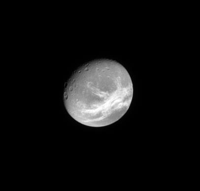 Wispy Dione
Caption NASA:"The Cassini Spacecraft looks toward the wispy, fractured terrain of the Trailing Hemisphere of the moon Dione. 
To learn more about Dione's "Wisps", see also PIA08960. 
Lit Terrain seen here is on the Trailing Hemisphere of Dione (about 1123 Km, or approx. 698 miles across). North on Dione is up and rotated 29° to the right. 

The image was taken in visible light with the Cassini Spacecraft narrow-angle camera on May 26, 2009. The view was acquired at a distance of approx. 1,3 MKM (about 808.000 miles) from Dione and at a Sun-Dione-Spacecraft, or Phase, Angle of 35°. 
Image scale is roughly 8 Km (about 5 miles) per pixel".
Parole chiave: Saturn's Moon - Dione