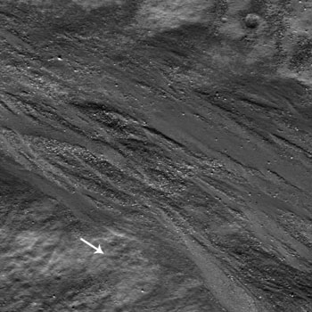 Epigenes A
A plethora of Boulders surrounds braided flows of impact melt along the Inner Wall of the Crater Epigenes A. As the melt moves toward the Crater Floor (direction indicated by white arrow), the flow buries and moves boulders. 

Epigenes A is an about 18-Km-diameter Impact Crater located at 66,9° North and 0,3° West, on the Rim of crater W. Bond. 
(this NAC image is 540 meters wide)
Parole chiave: The Moon from orbit - Craters - Epigenes A Crater