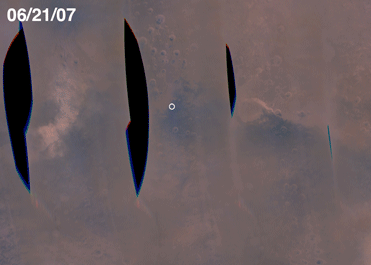 Planetary Dust Storm (GIF Movie)
NASA's Opportunity rover is literally seeing some of its darkest days. Both Mars Exploration Rovers have been riding out a regional dust storm for several weeks. Conditions became particularly dreary in the Meridiani Planum region where Opportunity sits, perched on the edge of "Victoria Crater." 

This image is a time-lapse composite where each horizon-survey image has been compressed horizontally (but not vertically) to emphasize the sky. The relative brightness and darkness of the sky from sol to sol (over a 30-sol period beginning June 14, 2007) is depicted accurately in these images, which view roughly the same part of the plains southwest of the rover. The images are approximately true color composites, generated from calibrated radiance data files using the panoramic camera's 601-nanometer, 535-nanometer and 482-nanometer filters. 

The rovers' atmospheric science team is concerned that smaller, regional dust storms could expand into a larger, globe-encircling storm. That could extend the time the sun stays obscured, challenging the capability of Opportunity's solar panels to produce enough electricity for the rover to function. 

Fortunately, as of July 19, 2007, the Opportunity site is clearing slightly. When the storm ends, atmospheric scientists hope to review data from the rovers that will help them determine what sort of dust was being lifted and distributed. 

The numbers across the top of the image report a measurement of atmospheric opacity, called by the Greek letter tau. The lower the number, the clearer the sky. Both Opportunity and Spirit have been recording higher tau measurements in July 2007 than they had seen any time previously in their three and a half years on Mars. The five sol numbers across the bottom correspond (left to right) to June 14, June 30, July 5, July 13 and July 15, 2007.

Parole chiave: GIF-Movie