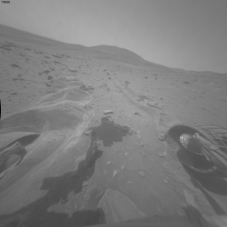 Movements and a Martian "Fly"?!? - Sol 2090 (GIF-Movie; credits: NASA/JPL-Caltech)
Caption NASA:"This blink comparison documents very slight forward movement of NASA's Mars Exploration Rover Spirit during a drive on the rover's 2090th Martian Day, or Sol (such as Nov., 19th, 2009). 

The two wide-angle views are from the right-side eye of Spirit's Front Hazard-Avoidance Camera (HazCam), one taken on Sol 2088 (Nov. 17) and the other after the drive on Sol 2090. The most obvious change is in the position of the shadow of the Rover Arm (RA), a change unrelated to the Rover's movement during the drive. 
The shadow is farther to the left on the "before" (Sol 2088) image than on the "after" (Sol 2090) image. 

In the "after" image, Spirit's left-front wheel has become slightly less buried in the soft soil in which the Rover had become embedded about 6 months ago. The right-front wheel, which has not been usable for driving since 2006, has been pushed perceptibly forward by the drive. The amount of forward motion is less than 1% of the distance that would have been covered on firm ground by the amount of wheel rotation commanded in the drive. 

The Sol 2090 drive was the second drive commanded after the Rover Team spent months using Earthbound testing and analysis to develop a strategy for attempting to drive Spirit out of this soft-soil site, called "Troy". 
Extrication drives are expected to make slow, if any, progress in coming weeks, and the probability of success in escaping from Troy is uncertain".

Nota Lunexit: Spirit, a nostro parere, riuscirà a venir fuori da Troy...
Parole chiave: GIF-Movie