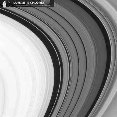 In the Rings (a GIF-Movie by Dr Gianluigi Barca - Lunar Explorer Italia/Italian Planetary Foundation)
The densest Regions of the Saturnian Ring System consist of the A and B-Rings, which are separated by the so-called "Cassini Division" (which was discovered in the AD 1675 by the Italian Astronomer Giovanni Domenico Cassini). Along with the C-Ring, which was discovered 75 years later (such as in the AD 1850), these three Regions together form the Main Rings of the Giant Gas Planet Saturn. 
The Main Rings are denser and contain larger Water Ice and Rocky Particles than the very tenuous so-called Dusty Rings, which include the D-Ring (extending inward, towards Saturn's Cloud Tops), the G and E-Rings, as well as other and even more tenuous (or also "diffuse") Rings and Ringlets (and, perhaps, even some Ring Arcs) which are all located beyond the three Main Rings (which can also be named as the "Main Ring System"). 
These "Diffuse Rings" are known as "dusty" because of the extremely small size of the Water Ice and Dust Particles which form them (and whose size can often be in the order of just one or two micrometers). Last, but not least, the narrow F-Ring - which rotates just off the Outer Edge of the A-Ring - is the most difficult one to be categorized, and that is because some parts of it are very dense, while others are extremely tenuous.
The brightness and purity of the Water Ice contained in the Rings has been often cited as evidence that they should (and could very well be) much younger than Saturn (some Scientists say - but this is, of course, just a speculation - that their age could be of approx. 100 Million Years only, since the infall of Meteoric Dust would have led to some very obvious darkening of the Rings themselves, if they had been older. However, a new research also indicates that the B-Ring may be massive enough to have diluted the infalling Meteoric Dust Material and thus avoided any substantial darkening of the entire Ring System. In addition to the above, the material forming the Rings may also be periodically recycled, as "Clumps" form within the Rings and then are disrupted by occasional Impacts. This last theory, if proven correct, could substantially explain the apparent youth of some of the Material existing within the whole Ring System.
The NASA - Cassini - UVIS Team, led by Dr Larry Esposito, used the so-called "Stellar Occultation Method" to discover something like 13 (thirteen) new Celestial Objects, ranging from approx. 27 metres to about 10 Km across, and all located within the F-Ring. These Objects appear to be translucent, thus suggesting that they could be temporary aggregates of Water Ice Boulders, each one of them being a few meters across. Dr Esposito believes that this could be the Basic (Mechanical) Structure that allows the formation and (somehow periodic) renewal of the entire Saturnian Ring System, such as Water Ice and Rocky Dust Particles first clumping together, and then being - as we suggested, maybe occasionally, maybe periodically - blasted apart.
Parole chiave: GIF-Movies - Saturn's Rings