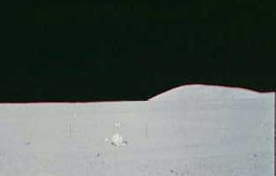 A HUGE Fake! (Part II)
Il secondo passaggio é stato facile: ho ritagliato (--> cropped) l'immagine, così come nel frame "falso", che vedremo alla fine. 
L'oggetto (in realtà sono almeno 4, dunque: gli oggetti!) sfuocato/i che vedete leggermente sulla sinistra (Sx) in basso, é/sono (ritengo) una sorta di "sacchetto a rete" (un contenitore?) ed altri strumenti lasciati al suolo dagli Astronauti per effettuare l'esperimento sulle Onde Sismiche. Nella foto finale, li vedrete come una sorta di chiazza scura (che sembra un ragno...). 

L'intento era quello di farlo passare per l'"ombra" del (falso) disco volante, ma un'eventuale ombra non sarebbe MAI potuta trovarsi lì (per giunta di quelle dimemsioni, fattezze e colori che vedrete), vista la posizione del Sole rispetto all'Astronauta che fotografava. 

Il Sole, infatti, NON era allo Zenit (altissimo, insomma), ma piuttosto basso ed alle sue spalle.

Didascalia NASA Originale: "Station 8 ALSEP / central Station / panorama". 

Nota: ALSEP =  Apollo Lunar Surface Experiments Package
Parole chiave: Lunar Surface - Controversial