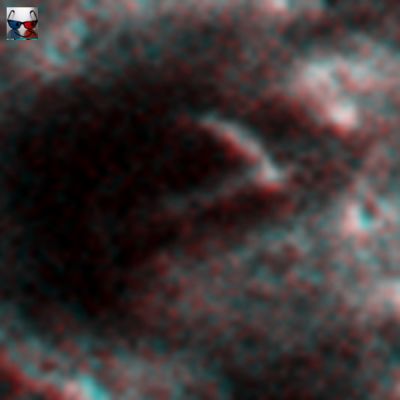 Unusual White "V-Shaped" Surface Feature (edm; High-Def-3D; credits: Dr M. Faccin & Lunar Explorer Italia)
L'avvicinamento al dettaglio controverso non ci è purtroppo di grande aiuto per capire "che cosa" stiamo guardando, ma la tridimensionalità ci permette di evidenziare qualche aspetto "certo":

1) si tratta di un profilo/rilievo (Surface Feature) assolutamente reale (non è un'ombra, non è un image-artifact e non è una Struttura Effimera);
2) la "V" che ci appare è la porzione superiore di un rilievo parzialmente infossato (è una sorta di "cresta" che emerge dal suolo) la cui porzione maggiore è immersa nell'ombra;
3) il rilievo controverso giace sul fianco di una leggera depressione naturale a forma di conchiglia la quale SEMBRA un cratere ma non lo è (e se si trattasse di un cratere, allora esso è talmente degradato che i suoi tratti distintivi essenziali - l'Outer Rim, su tutti - sono ormai indistinguibili);
4) l'albedo e la texture della "V" è la stessa dei profili esterni alla depressione su cui il rilievo si stende e quindi, da un punto di vista geologico, dobbiamo ritenere che il materiale che forma la "V" è dello stesso tipo (medesima natura) di quello che si trova nei suoi dintorni;
5) l'area scura che caratterizza il fondo della depressione non è un'ombra: è materiale scuro (sabbia, forse fango).

Oltre non possiamo andare, purtroppo...
Parole chiave: Mars from orbit - Controversial Surface Feature: "The V-Shaped Rock"