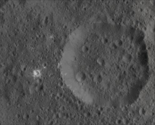 White Unnamed Crater on 1-Ceres (Absolute Natural Colors; credits for the additional process. and color.: Dr Paolo C. Fienga/Lunar Explorer Italia/Italian Planetary Foundation)
Today's APOD is an Extra Detail Magnification (or "EDM", for short) of yesterday's Contextual (or "CTX", for short) Frame, taken by the NASA - Dawn Spacecraft that shows us a small White Crater (---> also informally known as "White Spot") that is located in the Northern Hemisphere of the Dwarf Planet named 1-Ceres. 

Now, we ask you one (extremely complicated, in fact) question that you, however, should try to answer: why, on 1-Ceres, the huge and deep Impact Craters do not show "White Material" inside them, while, on the other hand, the small and shallow ones (Impact Craters) do? Probably because, but we, as IPF, cannot be sure of this (just like everyone else), the White Material, in the end, does not belong to/comes from the Sub-Surface of 1-Ceres (as we thought, at the beginning), but it belongs to/comes from the Impactors. And you, what do you think?...If you want to share your opinion, please, write us at alphacentauri@intercom.it

The picture was taken from an altitude of approx. 915 miles (such as about 1472,5461 Km) from the Surface, with a resolution of roughly 450 feet (such as about 137,16 meters) per pixel, was taken on August 21, 2015.

This image (which is a crop taken from an Original NASA - Dawn Spacecraft's b/w and NON Map-Projected frame published on the NASA - Planetary Photojournal with the ID n. PIA 19884 - Dawn HAMO Image 8) has been additionally processed, extra-magnified to aid the visibility of the details, contrast enhanced and sharpened, Gamma corrected and then colorized (according to an educated guess carried out by Dr Paolo C. Fienga-LXTT-IPF) in Absolute Natural Colors (such as the colors that a normal human eye would actually perceive if someone were onboard the NASA - Dawn Spacecraft and then looked ahead, towards the Surface of 1-Ceres), by using an original technique created - and, in time, dramatically improved - by the Lunar Explorer Italia Team.
Parole chiave: Dwarf Planets - 1-Ceres