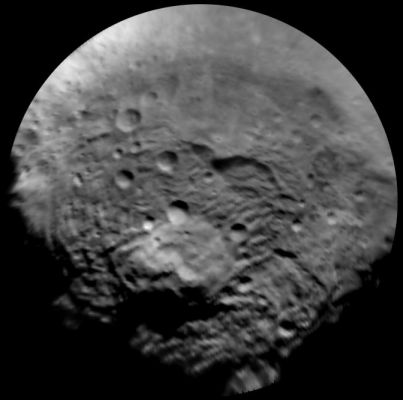 The South Pole of 4-Vesta
Caption NASA:"This image, taken by the framing camera instrument aboard NASA's Dawn Spacecraft, shows the South Polar Region of 4-Vesta, which has a diameter of about 330 miles (approx. 530 Km). The image was taken through the clear filter on July, 9th, 2011, as part of a rotation characterization sequence, and it has a scale of about 2,2 miles (approx. 3,5 Km) per pixel. 
To enhance details, the resolution was enlarged to .6 miles (roughly 1 Km) per pixel. 

This Region is characterized by rough topography, a large Mountain, Impact Craters, Grooves and steep Scarps. The original image was map-projected, centered at 55°
South Latitude and 210° East Longitude".
Parole chiave: Asteroids - 4-Vesta
