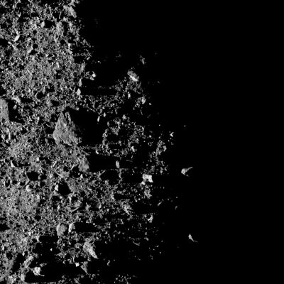 101955 Bennu - North Polar Terminator
Caption NASA:"This image shows a Region near asteroid Bennu’s North Pole on the Terminator Line (such as the line between the Asteroid’s day and night sides). 
The OSIRIS-Rex Spacecraft’s MapCam camera obtained the image on Feb. 20, 2019 while in orbit around the Asteroid from a distance of approx. 1,1 miles (such as about 1,8 Km). 
At this distance, each pixel covers approximately 4,5" (---> inches, such as about 12 cm) of 101955 Bennu’s Surface. The largest Boulder, located slightly left (Sx) of the center, measures around 52 feet (approx. 16 meters) across, which, for scale, is the length of the trailer on a semi-truck.

During the Mission’s Orbital Phase, OSIRIS-REx circled the Asteroid near 101955 Bennu’s Terminator Line. While this positioning helped to maintain the Spacecraft in a stable orbit, the half-light/half-dark view of it created challenging conditions for science imaging".
Parole chiave: Asteroids - 101955 Bennu