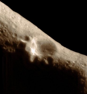NEAR's historic first image from Eros orbit (natural colors; credits: Lunexit)
On February 14, 2000, at 10:33 AM EST the NEAR Spacecraft was successfully inserted into orbit around 433 Eros, becoming the first artificial satellite of an asteroid. Just over an hour later, NEAR pointed its camera at the asteroid and took this picture from a range of 210 miles (330 km) above the surface. 
Mission navigators and operators will use this image and others to be taken later to traingulate on landmarks on the asteroid's surface, precisely measuring position of the spacecraft to plot NEAR's course. 

Features as small as a 100 feet (30 meters) across can be seen. This view shows the 3-mile (5-Km) impact crater which the Spacecraft has spied for over a week during its approach. The two smaller craters superimposed on its rim are each about 1,2 miles (approx. 2 Km) across. An enormous boulder a full 170 feet (50 meters) in size sits on the large crater's floor. Other key features of the surface are shallow subsurface layering exposed near the tops of crater walls, and shallow grooves crossing the surface and cutting the crater's rim. 

(Mosaic of images 0125957025 and 0125957087)
Parole chiave: Asteroids - 433-Eros