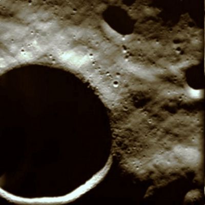 Schakleton Crater in natural colors
The Advanced Moon Imaging Experiment Camera (AMIE) obtained this image on 13 January 2006 - close to the time of Lunar Southern Summer - from a distance of about 646 Km over the surface and with a ground resolution of 60 mt per pixel. 
Shackleton crater lies at the Lunar South Pole (89,54° S. Lat. and 0° East Lng.) and has a diameter of approx. 19 Km.

SMART-1 monitored this area almost every orbit. This will allow to produce very high resolution maps of the area as well as illumination maps. The long shadows that surround the crater make it very hard to observe. The analysis of the data obtained allowed a very detailed map of its rim, surrounding ejectas and craters.

SMART-1 also made long repeated exposures to see inside the shadowed areas. The purpose was detecting the very weak reflected light from the crater rims, and therefore study the surface reflection properties (albedo) and its spectral variations (mineralogical composition). These properties could reveal patchy ice surface layers inside the crater. 

On the 2-kilometre wide inner edge of the crater ridge, at times barely visible from Earth, astronomers using ground radio-telescopes have recently reported they were not able to detect a distinctive signature of thick deposits of ice in the area. Earlier measurements by NASA's Lunar Prospector reported of hydrogen enhancement over large shadowed areas. 

"We still do not know if this hydrogen is due to enhanced trapping of solar wind, or to the water ice brought on the Moon by the bombardment of comets and asteroids," says Bernard Foing, ESA's SMART-1 Project Scientist. "These bodies may have deposited on the Moon patchy layers of ice filling about 1.5 percent of the areas in permanent shadow, down to one metre below the surface." 

"We need to analyse all remote sensing data sets consistently. Future lander and rover missions to the Moon will help in the search and characterisation of lunar polar ice, both on the surface and below the subsurface," Foing continues. "In any case, one day we may even be able to simply combine the implanted hydrogen and the oxygen extracted from lunar rocks to produce clean water, like we do in laboratory experiments on Earth.” 

The crater is named after Ernest Shackleton (1874-1922), an explorer famous for his Antartic expeditions. 

Parole chiave: The Moon from orbit - Crater Shackleton