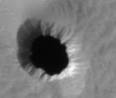 Collapse Pit
The ability to detect and explore Martian Caves is of intense interest to many disciplines in Planetary Science. Caves may expose entire sets of stratigraphic layers, providing windows into Mars' Geologic and Atmospheric histories.
Cave environments can also protect organic life from extremely harsh conditions on the Martian Surface, and may provide future human explorers with secure habitats. Accordingly, Caves are considered among the most promising locations to find preserved evidence of past or present microbial life.
Furthermore, the challenges associated with Mars Cave exploration may inspire a range new technologies, such as advanced robotics and target-specific landing capabilities.
Parole chiave: Mars from orbit - Collapse Features - Pit