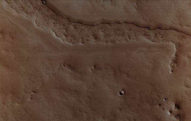 Inverted channels of Arabia Terra (2 - Natural Colors; credits for the additional process. and color.: Dr Paolo C. Fienga - Lunexit Team)
Original caption:"This MGS-MOC image shows a somewhat sinuous, nearly flat-topped Ridge, located in Eastern Arabia Terra. The ridgetop was once the Floor of a Valley, perhaps carved by running water. The Valley Floor, or material that covered the Floor, was more resistant to erosion than the surrounding rock into which the Valley was cut. Thus, over time, the Valley disappeared and its Floor was left standing high as a Ridge. Inverted Valleys are common on Mars, but they also occur on Earth". 

Location near: 10,8° North Lat. and 313,2° West Long.
Image width: width: ~3 Km (~1,9 mi)
Illumination from: lower left 
Season: Northern Winter
Parole chiave: Mars from orbit - Channels - Inverted Channels