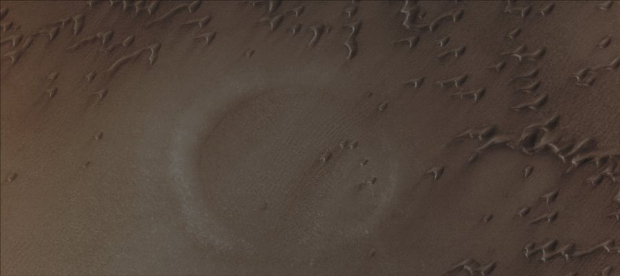 Under the Sand (Absolute Natural Colors; credits for the additional process. and color.: Dr Paolo C. Fienga - Lunexit Team)
Caption NASA originale:"This MGS-MOC image shows a partially-buried crater in the North Polar Region of Mars. 
The circular feature is surrounded and partly overlain by some of the many, many sand dunes in the area. The steepest slopes on each dune — their "slip faces" — face toward the SouthEast, indicating that the dominant winds responsible for sand transport in this Region come from the NorthWest".

Location near: 76,0° North; 82,2° West
Image width: ~3 Km (~1,9 mi)  
Illumination from: lower left  
Season: Northern Spring
Parole chiave: Mars from orbit - Craters - Buried Crater